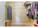 Spacious walk-in closet with metal shelving, extra storage, and neutral carpet at 16857 W Villagio Dr, Surprise, AZ 85387