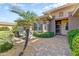 Charming courtyard with brick pavers, lush greenery, and a cozy outdoor seating area at 16857 W Villagio Dr, Surprise, AZ 85387