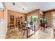 Bright dining room with a glass table, patio access, and tiled floors for easy maintenance at 16857 W Villagio Dr, Surprise, AZ 85387