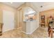 Welcoming entryway flows into an open-concept kitchen and dining area, featuring tile floors at 16857 W Villagio Dr, Surprise, AZ 85387