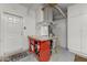 This garage features a red table, tool storage, and white cabinets at 16857 W Villagio Dr, Surprise, AZ 85387