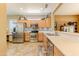 Well-lit kitchen boasts stainless steel appliances, light wood cabinets, and an open layout for easy entertaining at 16857 W Villagio Dr, Surprise, AZ 85387