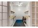 Large office space featuring two desks and a fan at 16857 W Villagio Dr, Surprise, AZ 85387