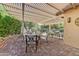 This outdoor patio features brick flooring, a stone wall, and trellis at 16857 W Villagio Dr, Surprise, AZ 85387