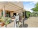 Charming backyard with a covered patio, a stone water feature, and a lush garden at 16857 W Villagio Dr, Surprise, AZ 85387