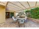 Back patio with a lattice cover, outdoor kitchen, and comfortable seating, perfect for entertaining at 16857 W Villagio Dr, Surprise, AZ 85387