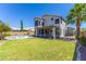 Expansive backyard features a lush lawn, mature trees, and a sparkling pool, perfect for outdoor enjoyment at 1694 E Campbell Ave, Gilbert, AZ 85234