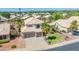 Exterior aerial of a suburban home with a three car garage, tiled roof and mature palm trees at 1694 E Campbell Ave, Gilbert, AZ 85234