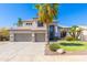Charming two-story home features a three-car garage, desert landscaping and a well-manicured lawn at 1694 E Campbell Ave, Gilbert, AZ 85234