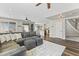 Open concept living area featuring a large sectional sofa, wood floors and kitchen access at 1694 E Campbell Ave, Gilbert, AZ 85234