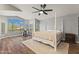 Spacious main bedroom boasts a four-poster bed, ample natural light, and wood-style flooring at 1694 E Campbell Ave, Gilbert, AZ 85234