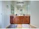 Bright bathroom featuring a double sink vanity with decorative mirror and accent lighting above at 1707 E Carob Dr, Chandler, AZ 85286