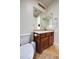 Bathroom featuring a toilet, vanity with storage, sink and mirror at 1707 E Carob Dr, Chandler, AZ 85286
