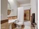 Well lit bathroom featuring a tub and shower combination with decorative brown tile and white sink and toilet at 1707 E Carob Dr, Chandler, AZ 85286