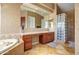 Bathroom features a soaking tub, vanity with cabinets, and a tiled glass block walk-in shower at 1707 E Carob Dr, Chandler, AZ 85286
