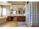 Bathroom featuring a glass block shower, soaking tub, vanity with cabinets, and neutral tile flooring at 1707 E Carob Dr, Chandler, AZ 85286