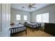 Bedroom featuring carpet, ceiling fan, two beds, and two windows at 1707 E Carob Dr, Chandler, AZ 85286