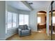 Carpeted bedroom with a chair, view of a window and access to a bathroom, providing comfort and convenience at 1707 E Carob Dr, Chandler, AZ 85286