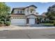 Spacious two-story home featuring a three-car garage and a well-manicured front yard at 1707 E Carob Dr, Chandler, AZ 85286