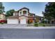 Inviting home exterior with a three-car garage and charming front yard landscaping at 1707 E Carob Dr, Chandler, AZ 85286