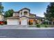 Charming exterior of home with a well-maintained front yard and a spacious three-car garage at 1707 E Carob Dr, Chandler, AZ 85286