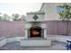 Outdoor fireplace featuring decorative tile is perfect for enjoying the backyard on cool evenings at 1707 E Carob Dr, Chandler, AZ 85286