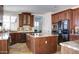 Well-equipped kitchen features granite counters, stainless appliances, and an island cooktop at 1707 E Carob Dr, Chandler, AZ 85286