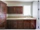 Laundry room has lots of wood cabinet space and a utility sink near the entry door at 1707 E Carob Dr, Chandler, AZ 85286