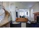Spacious living room with stone fireplace, staircase, and views into dining room at 1707 E Carob Dr, Chandler, AZ 85286