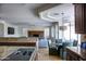 Bright living room featuring a fireplace, ceiling fan, and view into the kitchen at 1707 E Carob Dr, Chandler, AZ 85286
