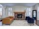 Inviting living room features a stone fireplace, plush seating, and bright windows at 1707 E Carob Dr, Chandler, AZ 85286