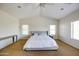 Spacious main bedroom with vaulted ceilings, ceiling fan, carpeted floors, and windows for natural lighting at 1707 E Carob Dr, Chandler, AZ 85286