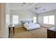 Spacious main bedroom with vaulted ceilings, ceiling fan, carpeted floors, and windows for natural lighting at 1707 E Carob Dr, Chandler, AZ 85286