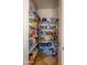 Walk in pantry with tile floor and ample white shelving stocked with food, appliances, and household goods at 1707 E Carob Dr, Chandler, AZ 85286