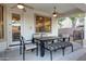 Covered patio with ceiling fans, a dining table, and comfortable seating at 1707 E Carob Dr, Chandler, AZ 85286
