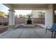 Covered outdoor patio with outdoor fireplace surrounded by seating areas at 1707 E Carob Dr, Chandler, AZ 85286