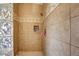 Shower featuring glass block window, neutral tiling, and tiled inset at 1707 E Carob Dr, Chandler, AZ 85286