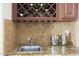 Cozy wet bar with a small sink, granite countertop, and wine rack at 1707 E Carob Dr, Chandler, AZ 85286
