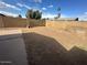 Large empty backyard with block wall and concrete patio area at 1841 S Spruce --, Mesa, AZ 85210