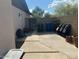 Backyard with block fence, trash cans, chairs, and potted plants at 1841 S Spruce --, Mesa, AZ 85210