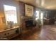 Living room featuring a brick fireplace, mantle decorations and open access to the adjoining kitchen at 1841 S Spruce --, Mesa, AZ 85210