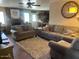 Cozy living room with plush sofas, brick fireplace, and natural light streaming through the windows at 1841 S Spruce --, Mesa, AZ 85210