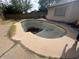 Empty in-ground pool needing repair next to the side of the house at 1841 S Spruce --, Mesa, AZ 85210