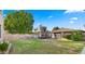 Expansive backyard with a trampoline and mature tree, perfect for outdoor activities at 18518 E Ashridge Dr, Queen Creek, AZ 85142