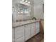 Bright bathroom with a white cabinet, granite countertop, and a large mirror at 18518 E Ashridge Dr, Queen Creek, AZ 85142