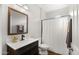 Clean, bright bathroom featuring a vanity with sink, mirror, and a shower with curtain at 18518 E Ashridge Dr, Queen Creek, AZ 85142