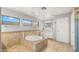 Bright bathroom featuring tiled floors and walls, soaking tub and large windows at 18518 E Ashridge Dr, Queen Creek, AZ 85142
