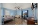 Comfortable bedroom with wood floors, a large window and modern ceiling fan at 18518 E Ashridge Dr, Queen Creek, AZ 85142
