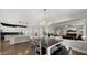 Open-concept dining area next to kitchen and living spaces, with a modern chandelier and ample seating at 18518 E Ashridge Dr, Queen Creek, AZ 85142