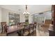 Elegant dining room with hardwood floors, large windows, and a wooden dining table with chairs at 18518 E Ashridge Dr, Queen Creek, AZ 85142